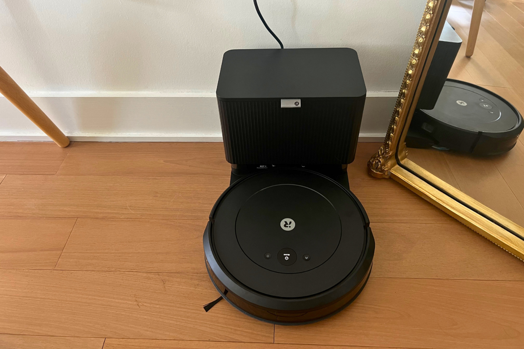 iRobot Roomba Combo 2 Essential and dock sitting against wall by mirror