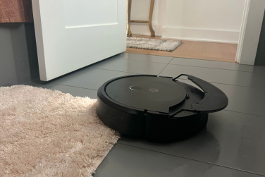 Roomba Combo 10 Max cleaning tile floor while lifting mopping pad over rug