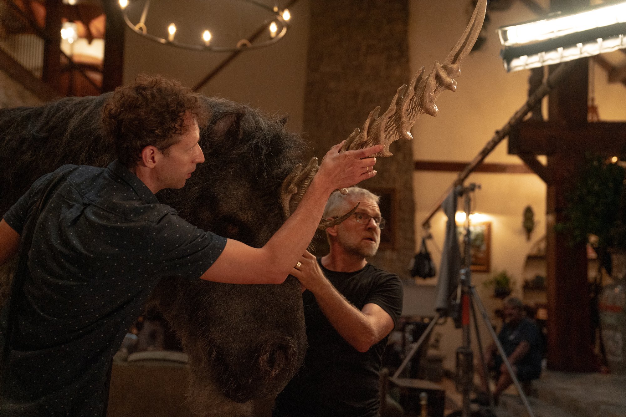 Puppeteers man a unicorn puppet in "Death of a Unicorn."