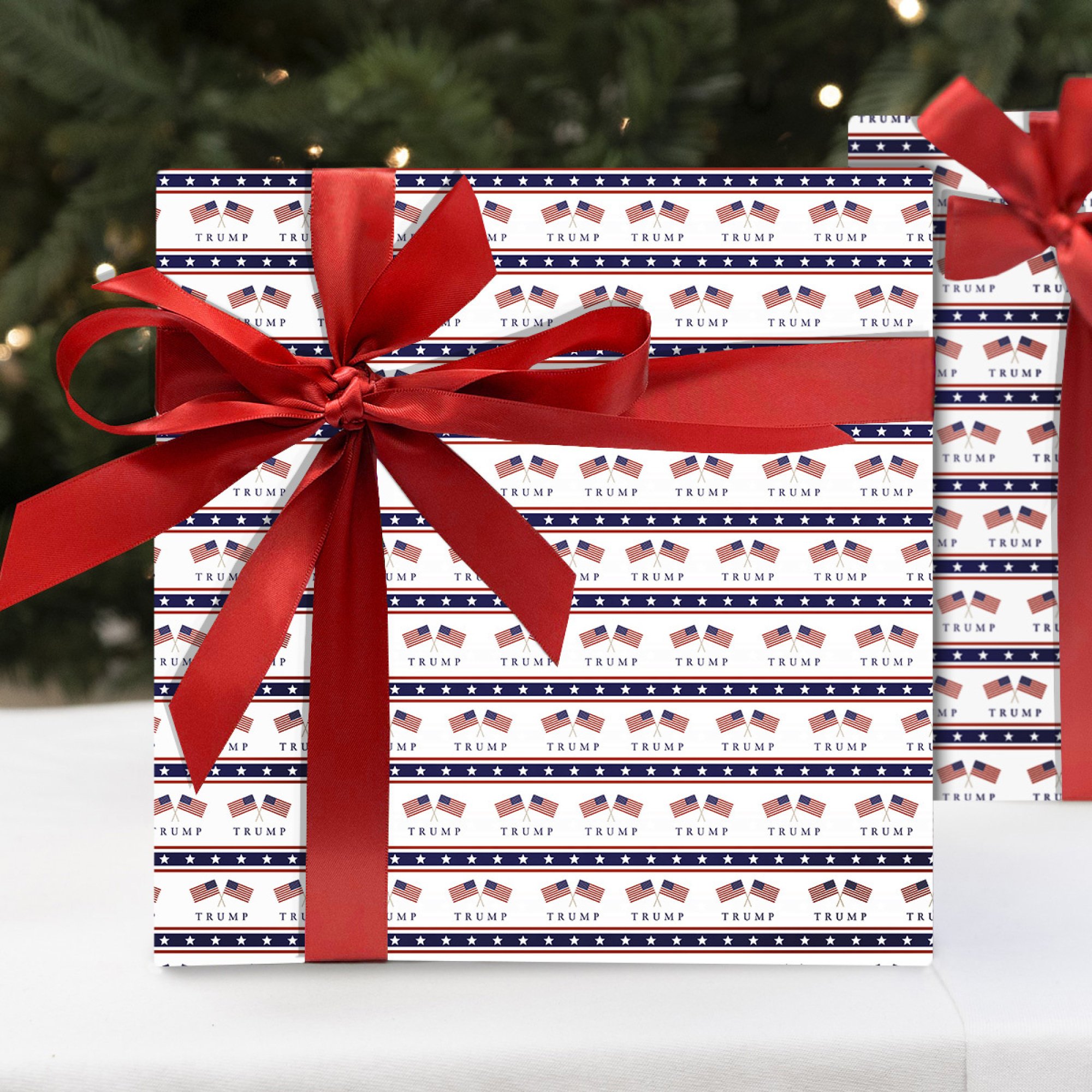 A photoshopped image of a Christmas present wrapped in patterned paper featuring crossed flags and the word "Trump".