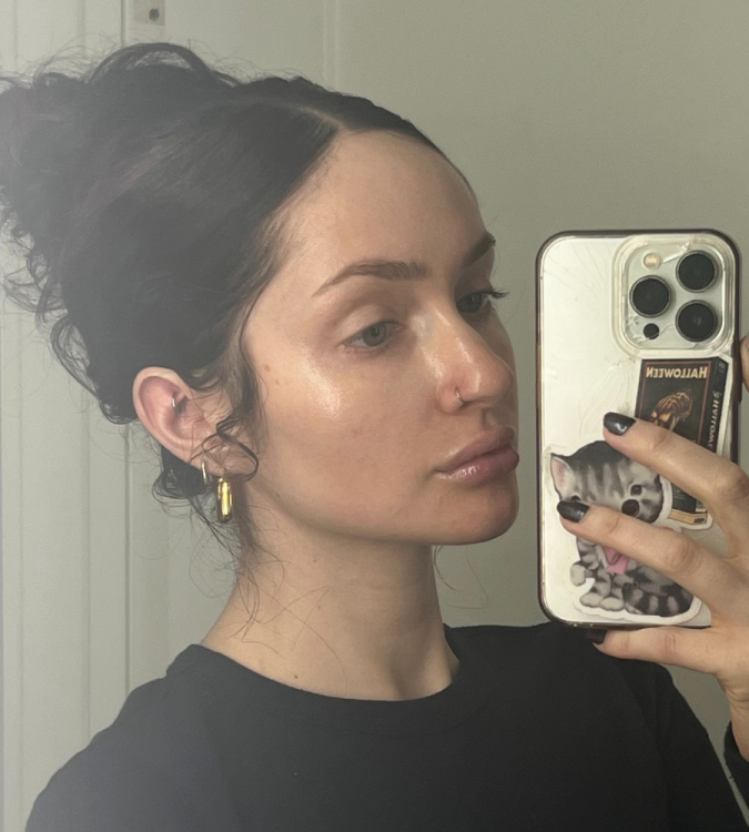 Leah taking mirror selfie showing face without makeup