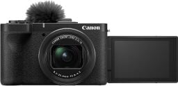 A Canon Powershot camera body with lens and fuzzy mic attached to the top