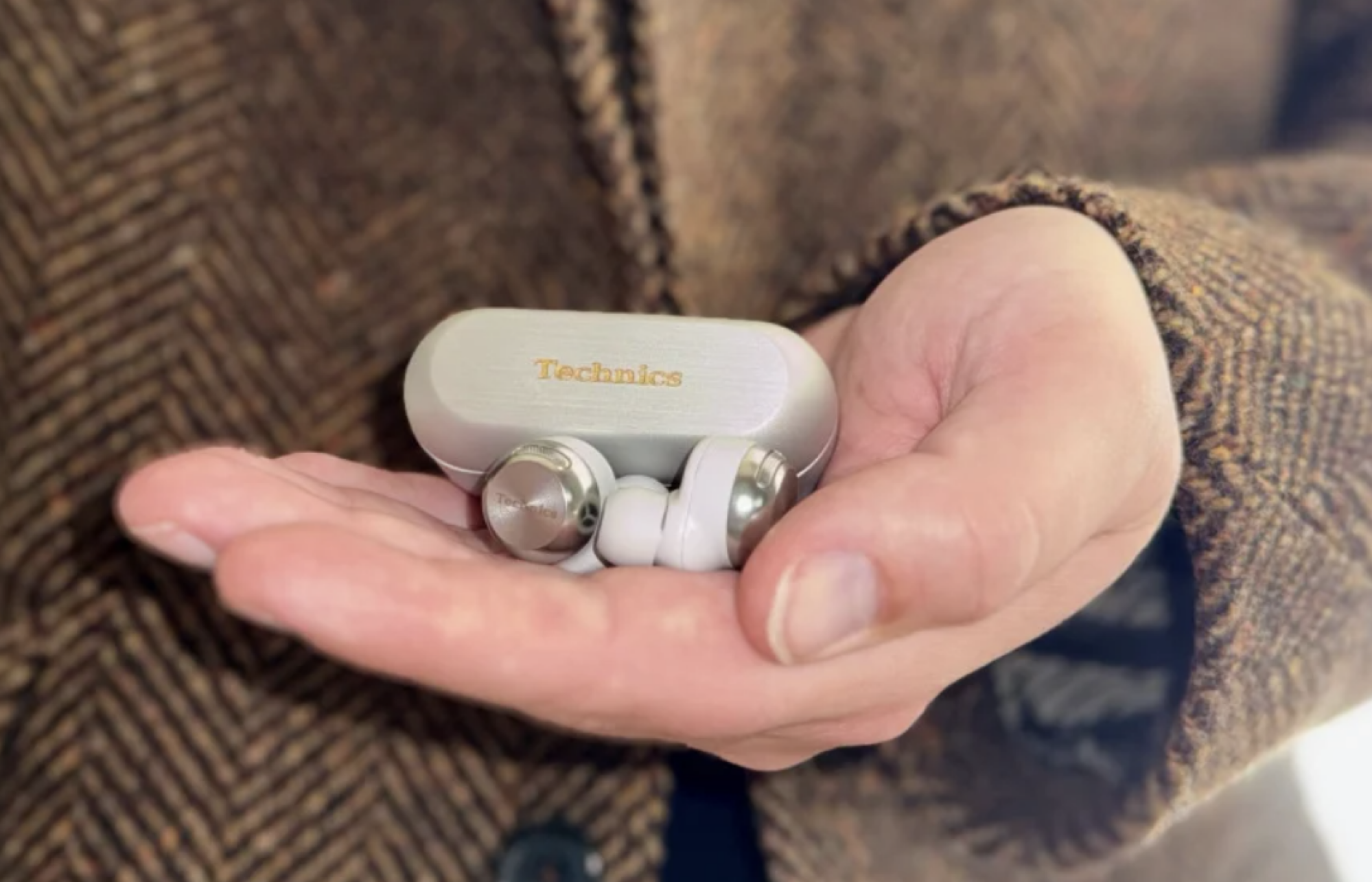 hand holding earbuds