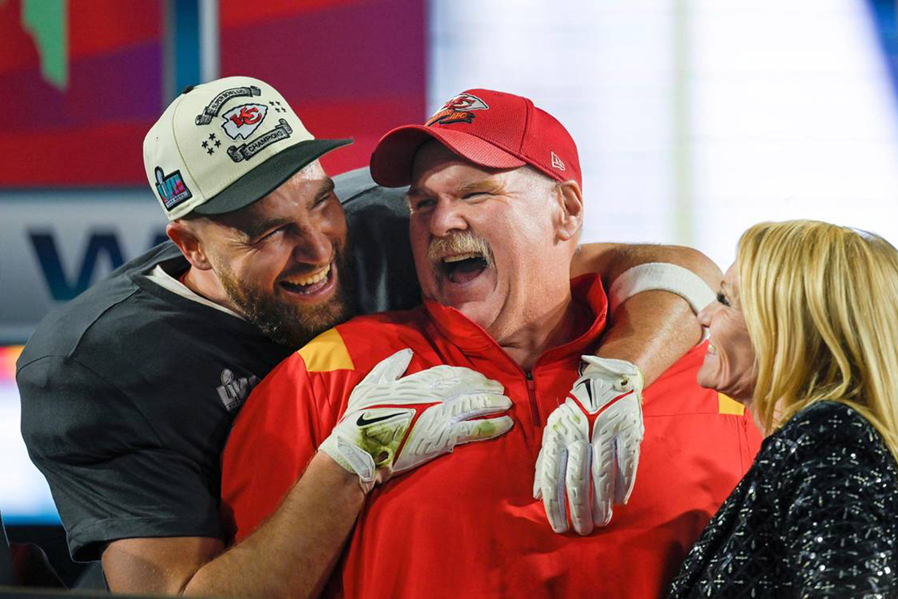 Kansas City Chiefs tight end Travis Kelce (87) hugs Chiefs Head Coach Andy Reid as Tammy Reid looks on after the Chiefs won Super Bowl LVII, defeating the the Philadelphia Eagles, 38-35, on Sunday, Feb. 12, 2023, at State Farm Stadium in Glendale, Arizona. (Tammy Ljungblad/Kansas City Star/Tribune News Service via Getty Images)