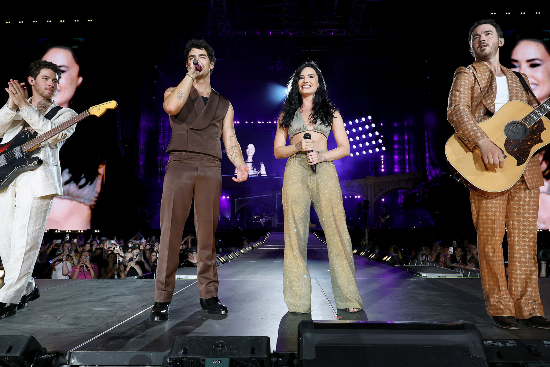 (L-R) Nick Jonas, Joe Jonas, Demi Lovato, and Kevin Jonas perform onstage during the Jonas Brothers: JONAS20 Greetings From Your Hometown tour kick off at Met Life Stadium on August 10, 2025 in East Rutherford, New Jersey.