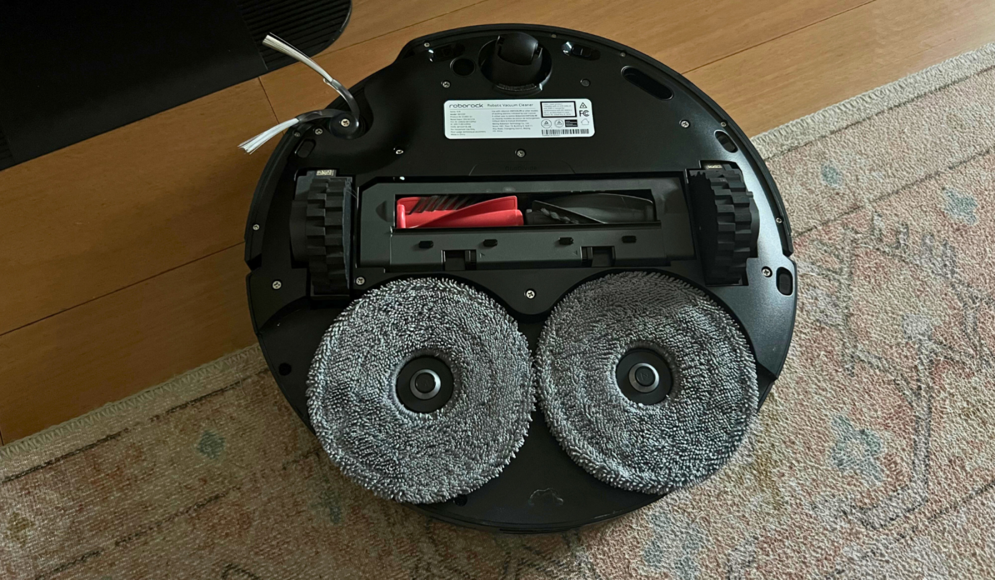 Underside of Roborock Saros 10R robot vacuum showing mopping pads and brushrolls