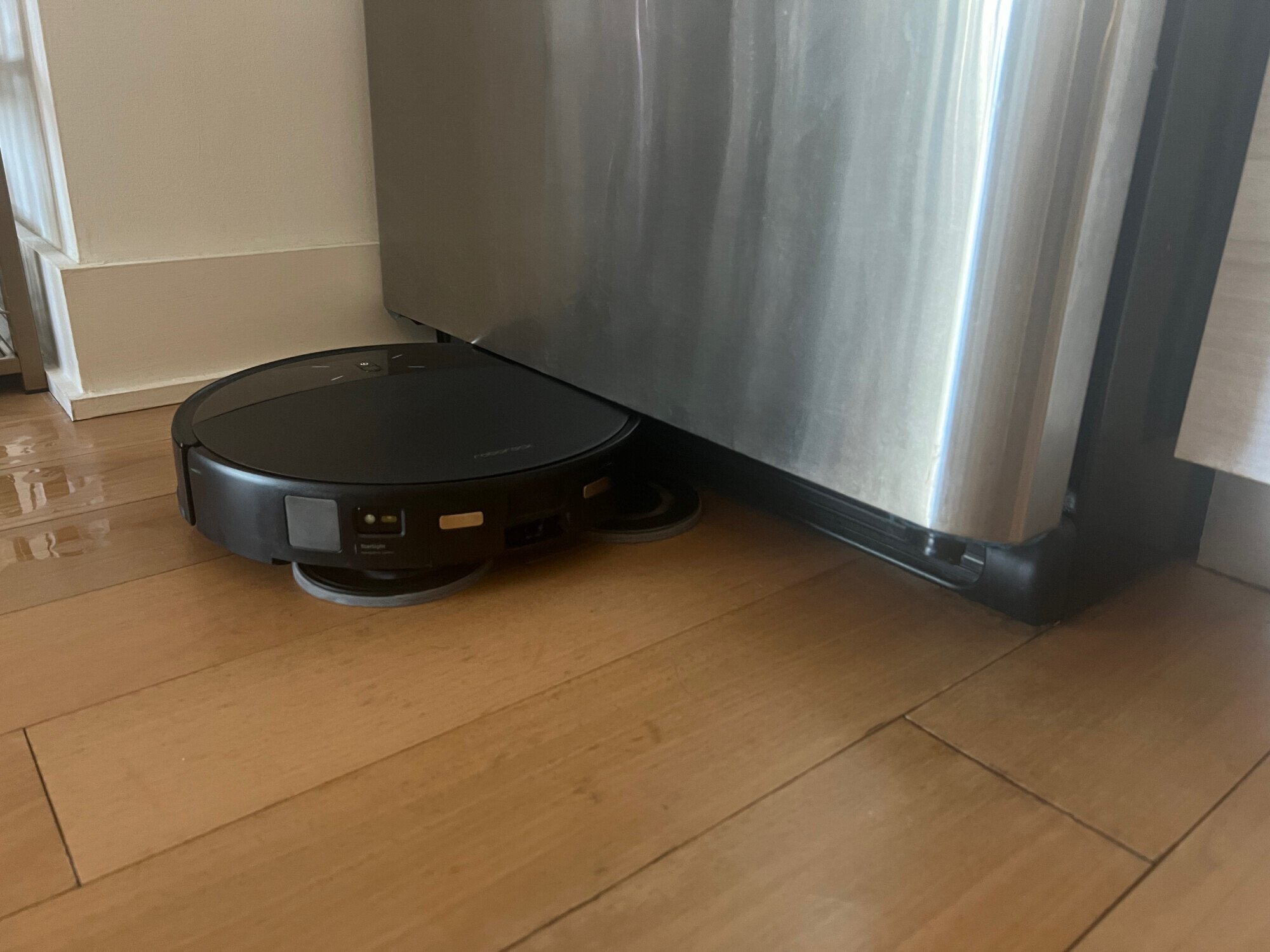 Roborock Saros 10R mopping hardwood floor under refrigerator