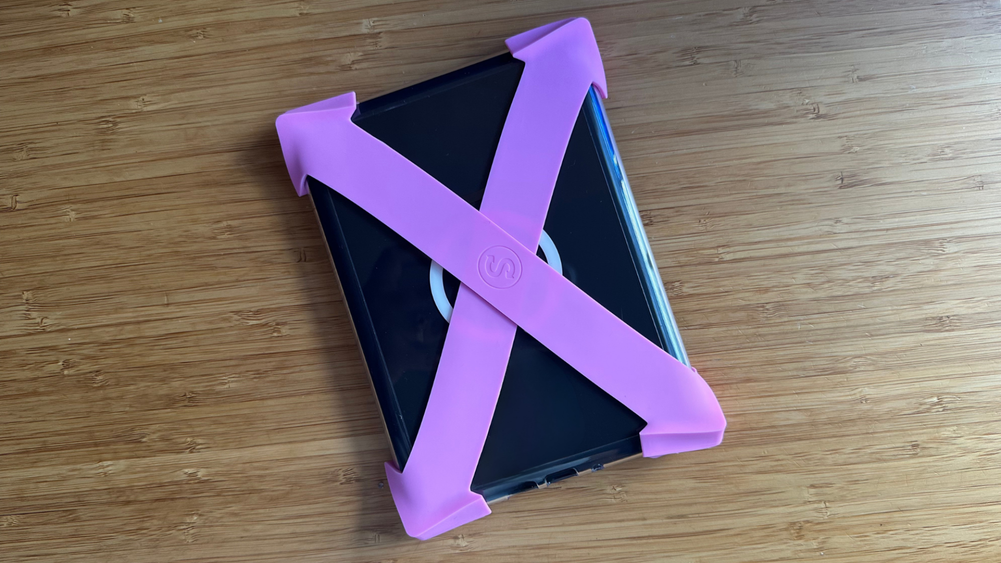 A Kindle with Strapsicles straps attached to it.