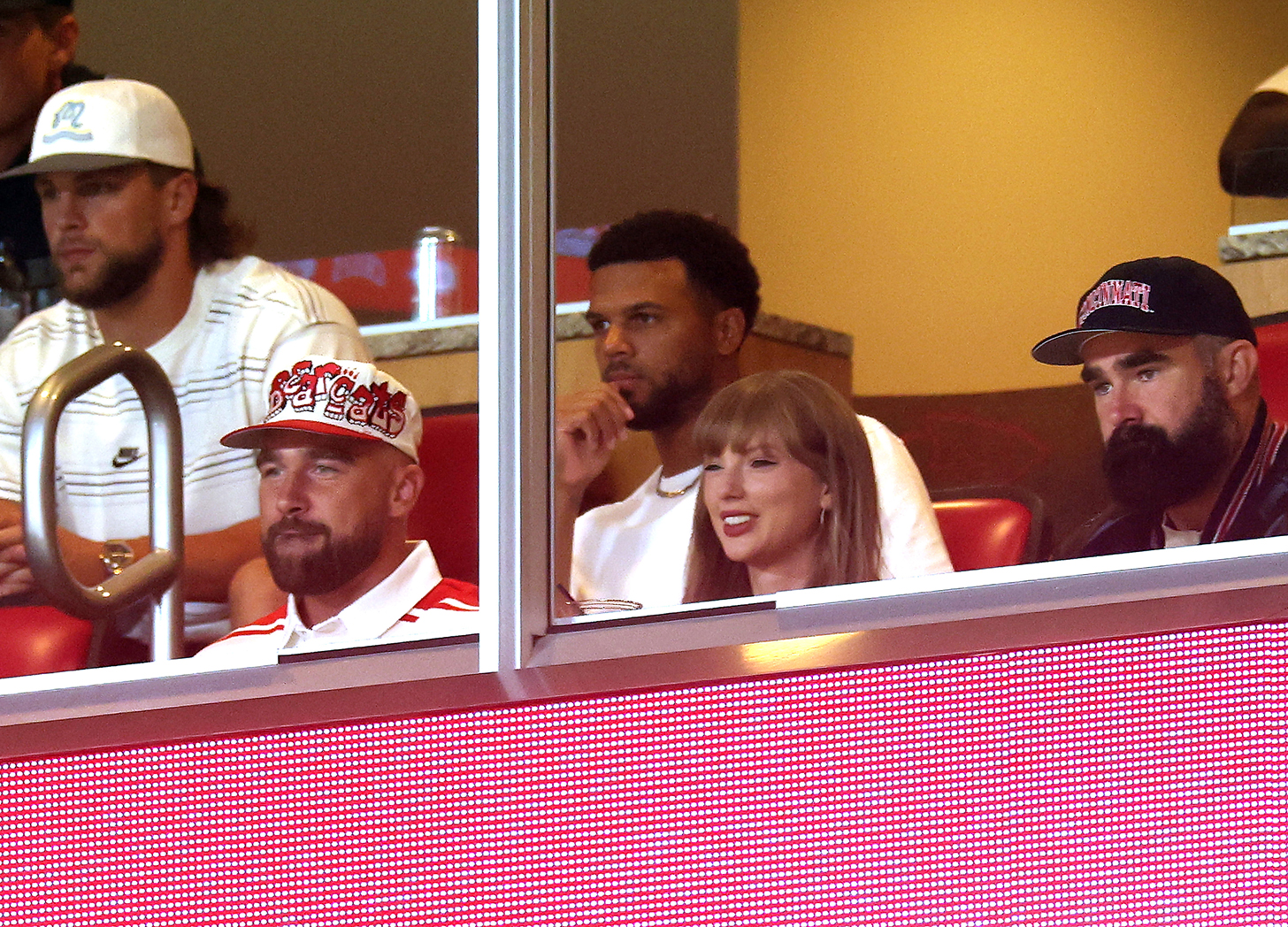 Travis Kelce #87 of the Kansas City Chiefs, Taylor Swift and Jason Kelce watch during the first half of the game between the Cincinnati Bearcats and the Nebraska Cornhuskers at Arrowhead Stadium on August 28, 2025 in Kansas City, Missouri.