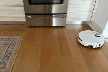 Dreame Aqua10 Ultra Roller robot vacuum mopping hardwood floor near oven