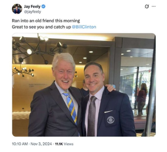 Jay Feely and Bill Clinton pose together, smiling, in a well-lit modern setting, showcasing a friendly reunion.